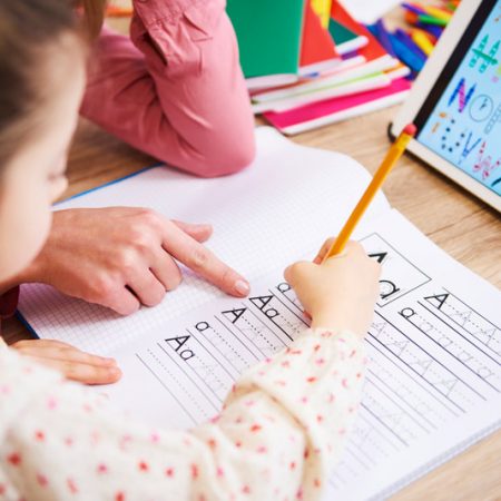 close-up-of-mother-helping-her-child-with-homework-234SWAL.jpg کمک مادر به فرزند